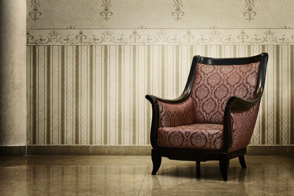 Empty chair in a softly lit room representing loneliness, emotional isolation, self-doubt, and recovery from emotional abuse.